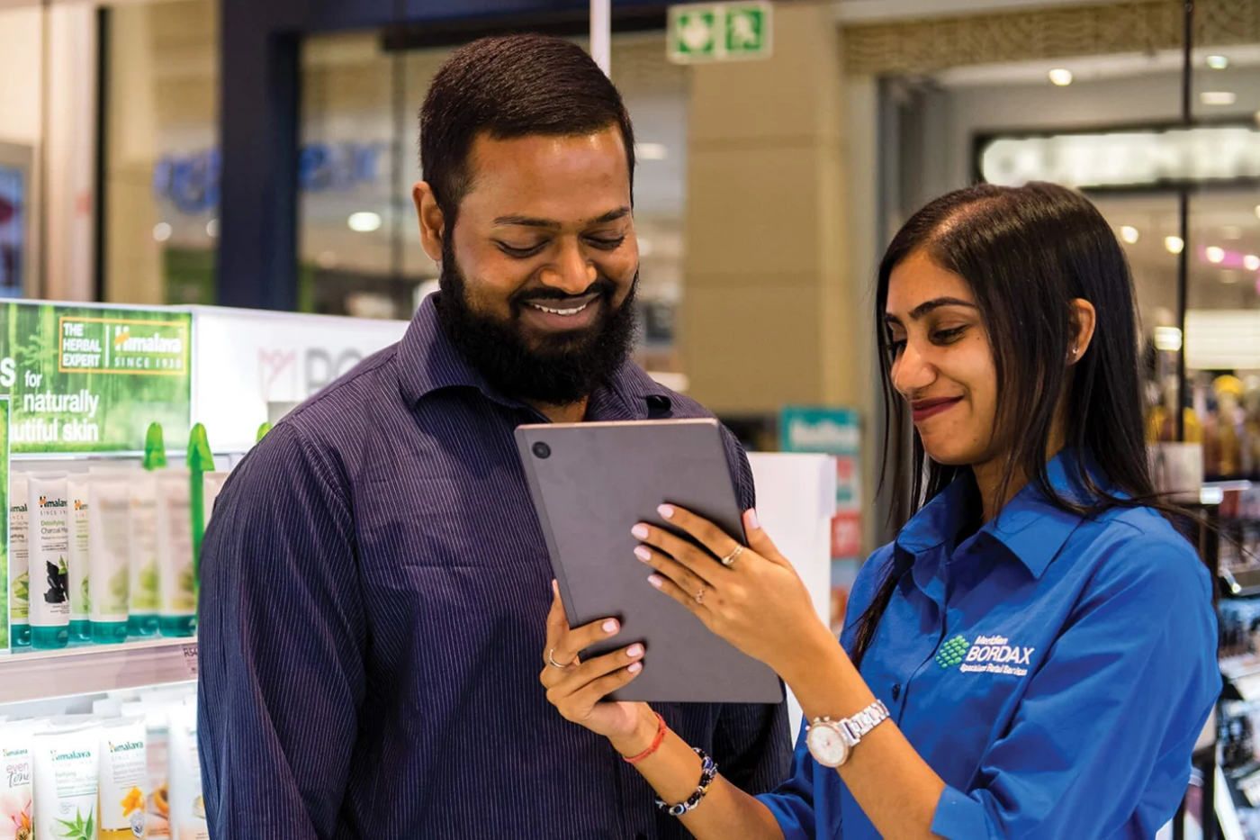 Bordax field agent conducting an in-store retail audit on a tablet with a store manager